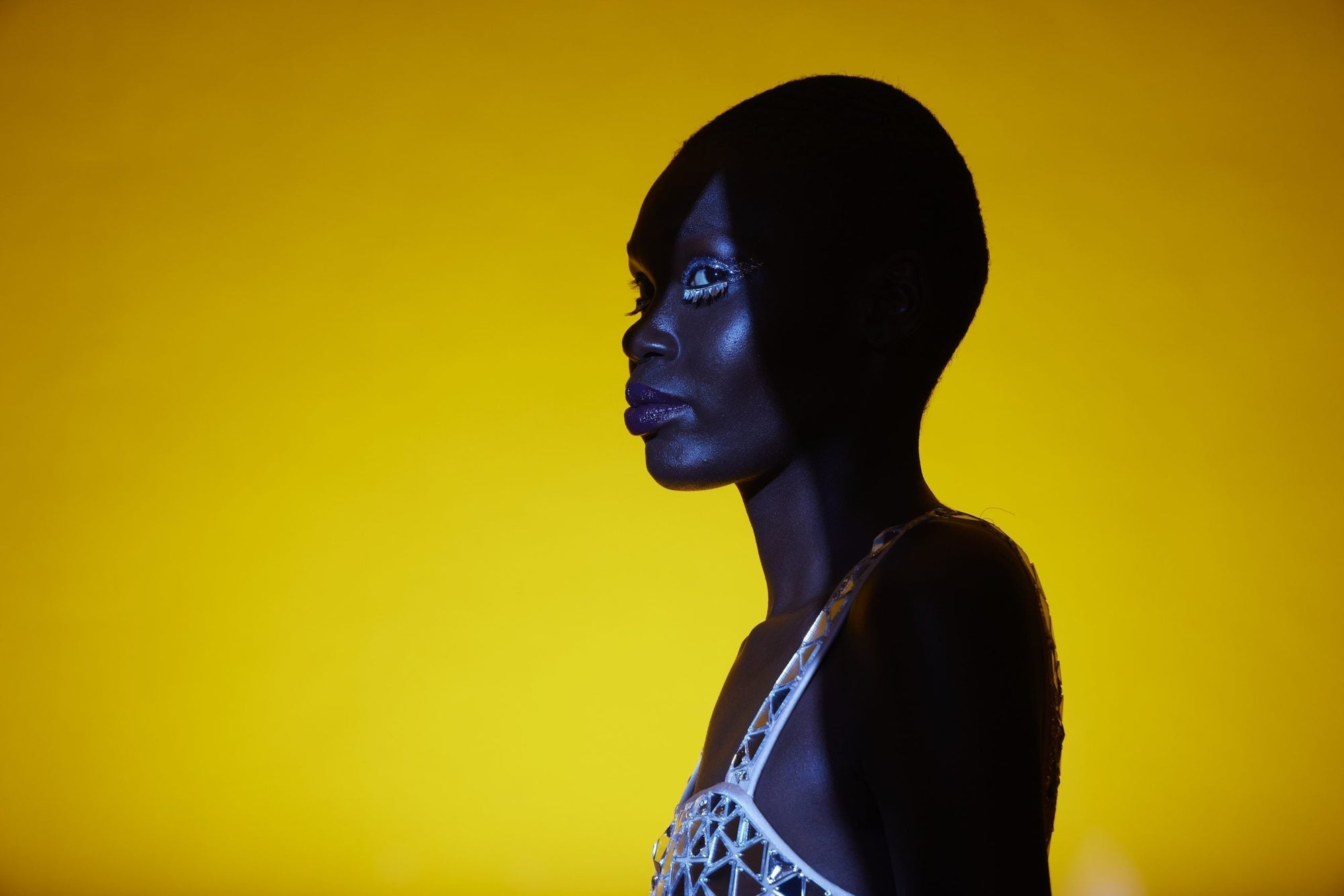 Optical Spot by Lindsay Adler with a blue/violet gel on key light and a yellow/orange gel on the backlight