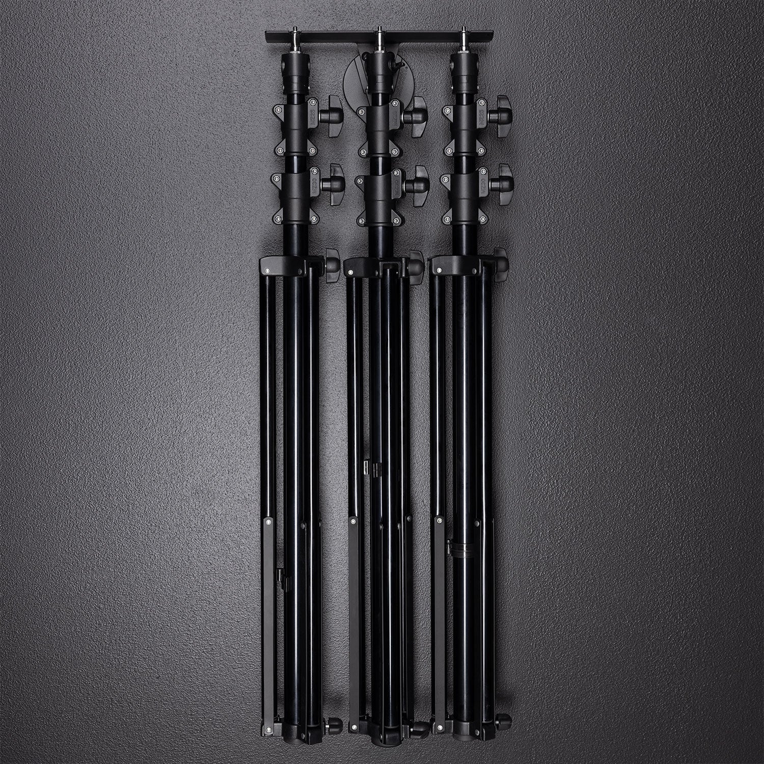 Float Wall Mount Light Stand Hanger shown with light stands in storage