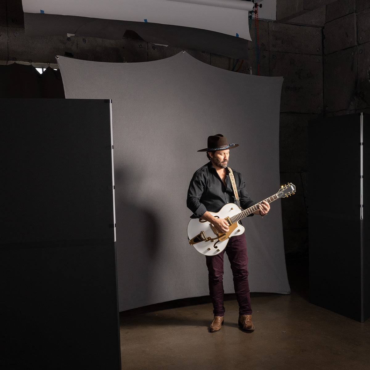 Studio Portrait of Musician Using 8' x 8' X-Drop Pro Backdrop