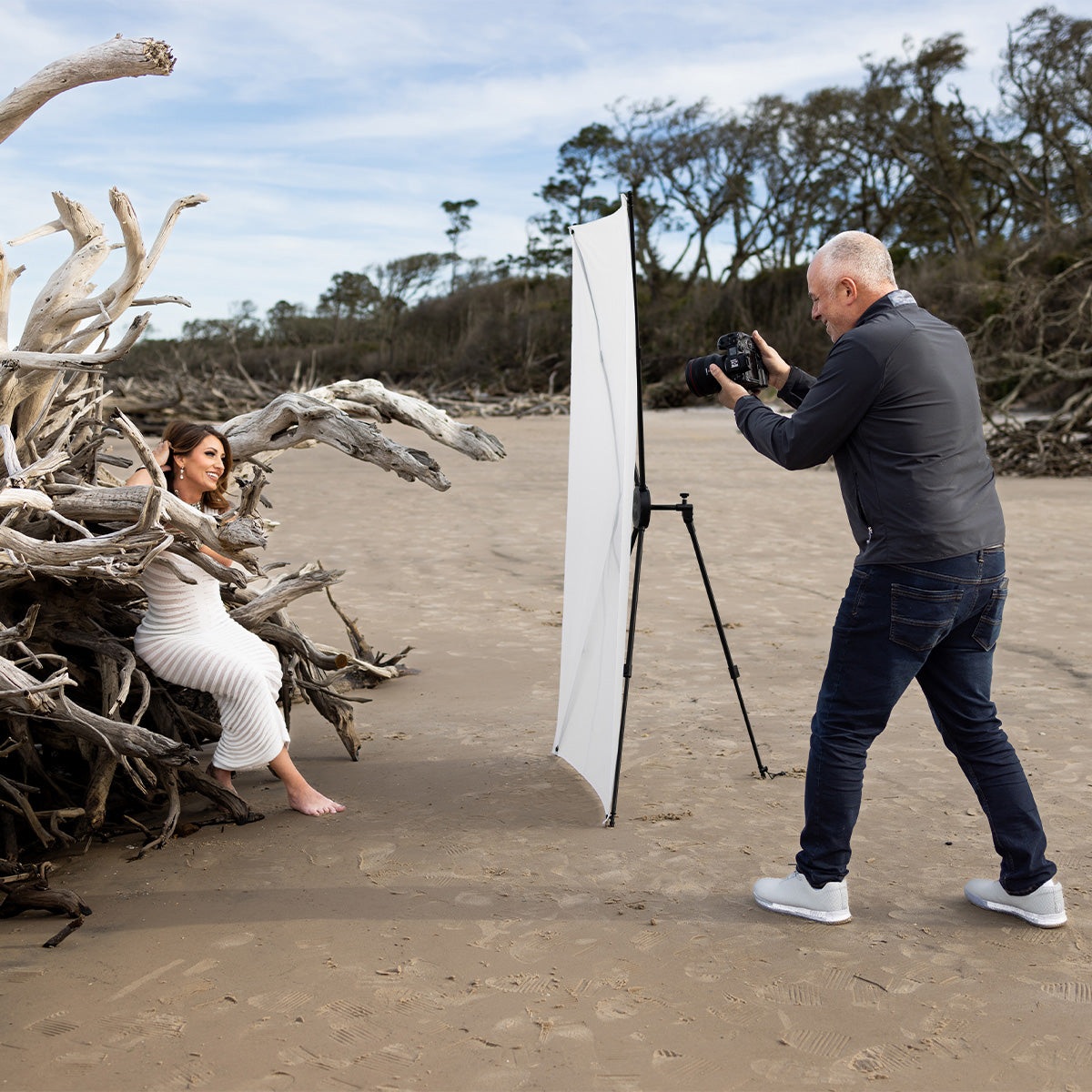 Model being photographed by Sal Cincotta on the beach using the Fusion light control system diffusion fabric