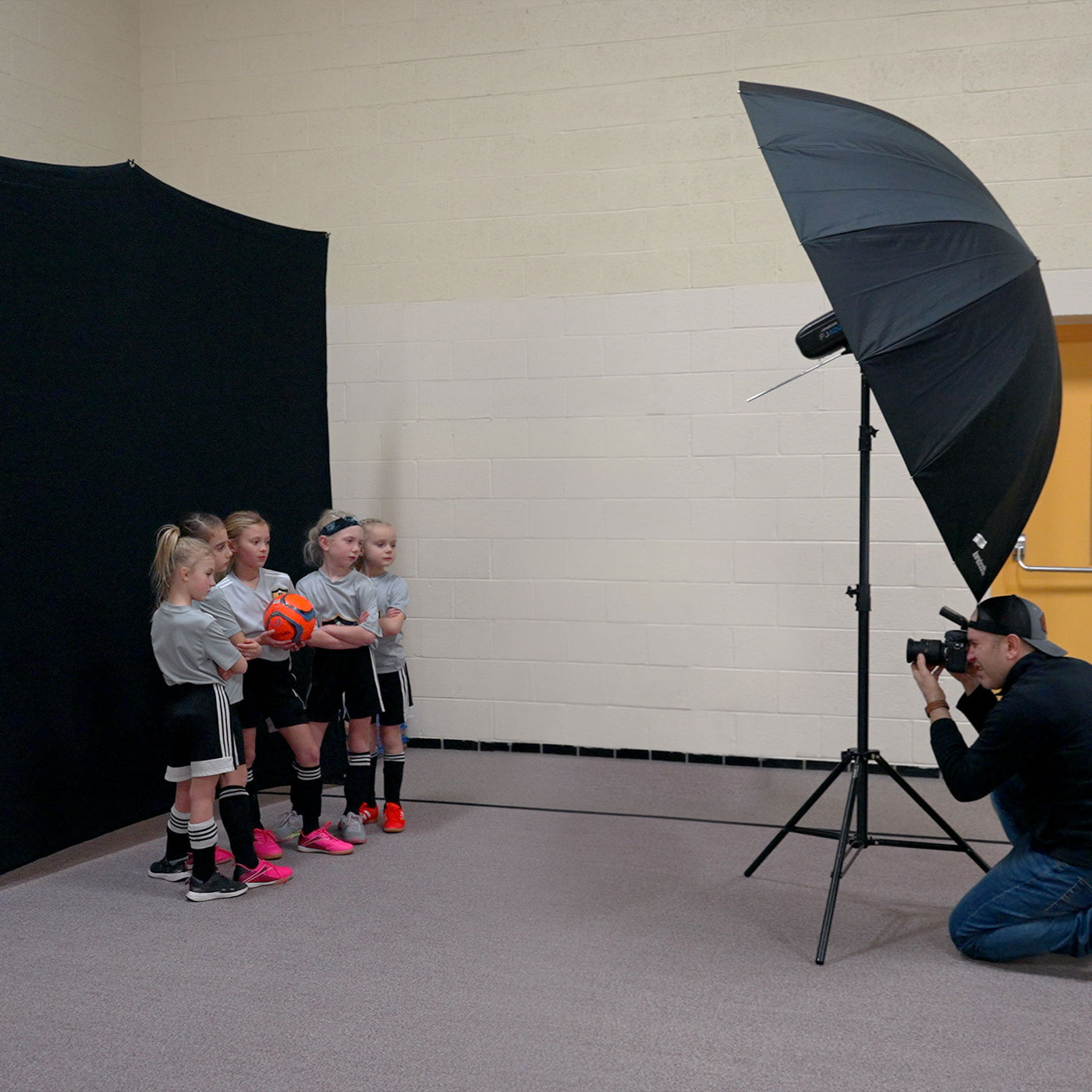 Soccer team portrait shoot using 8' x 8' X-Drop Pro wrinkle-resistant backdrop
