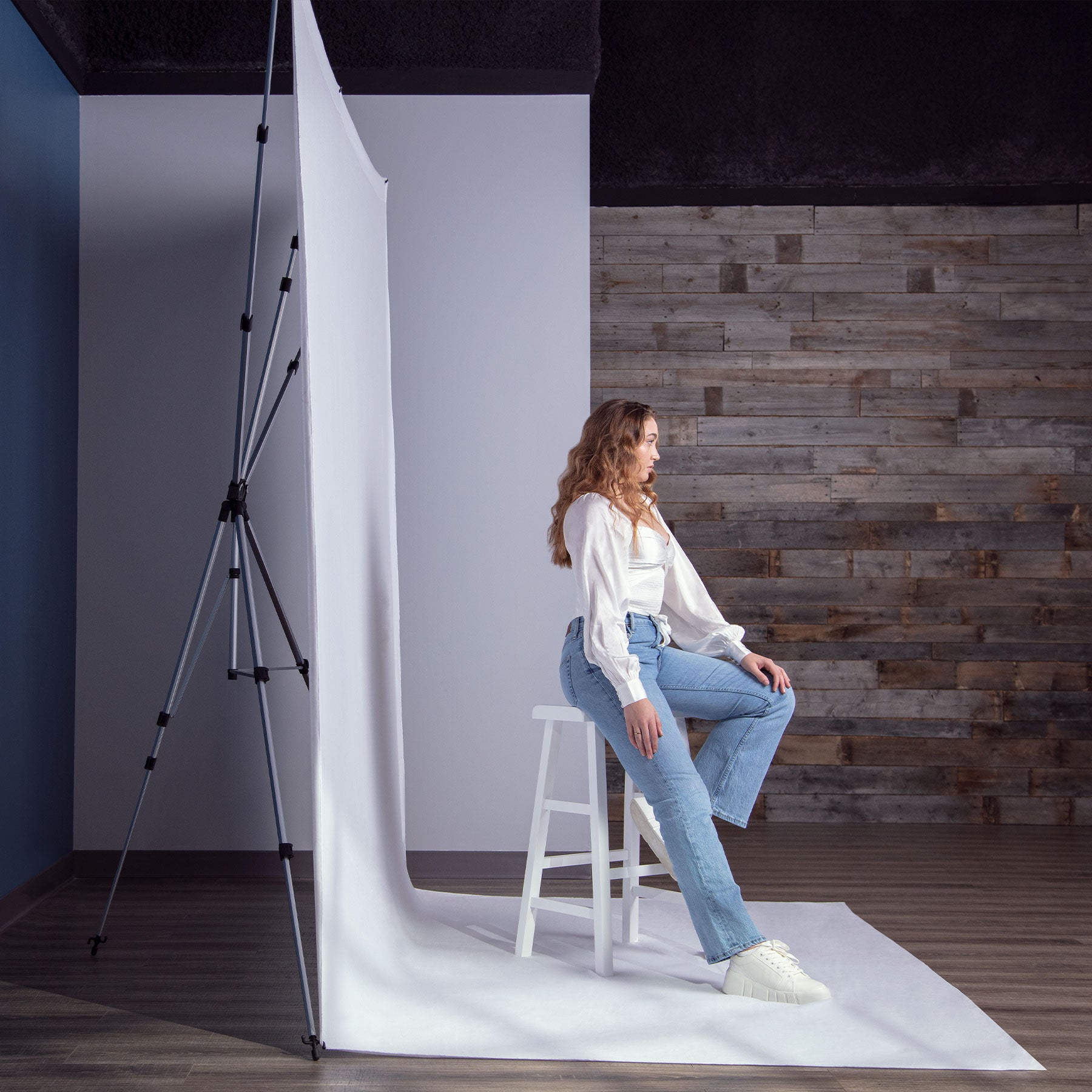 Portrait photo shoot using X-Drop Pro Backdrop Stand showing adjustable depth