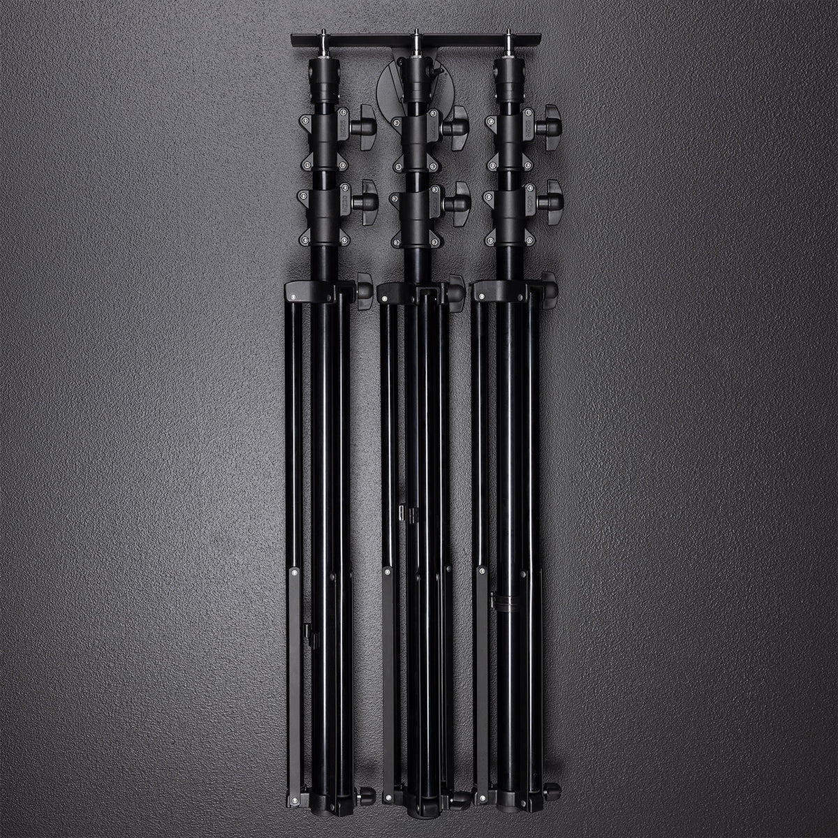 Float Wall Mount Light Stand Hanger shown with light stands in storage