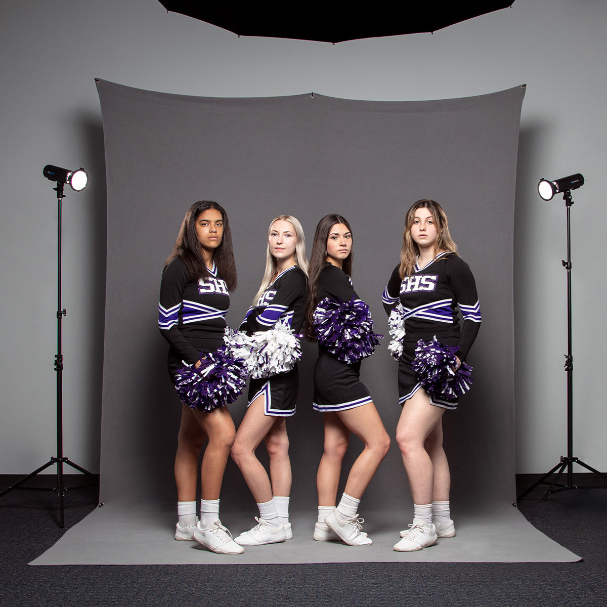 Studio Portrait of Cheerleaders Using 8' x 13' X-Drop Pro Sweep Backdrop