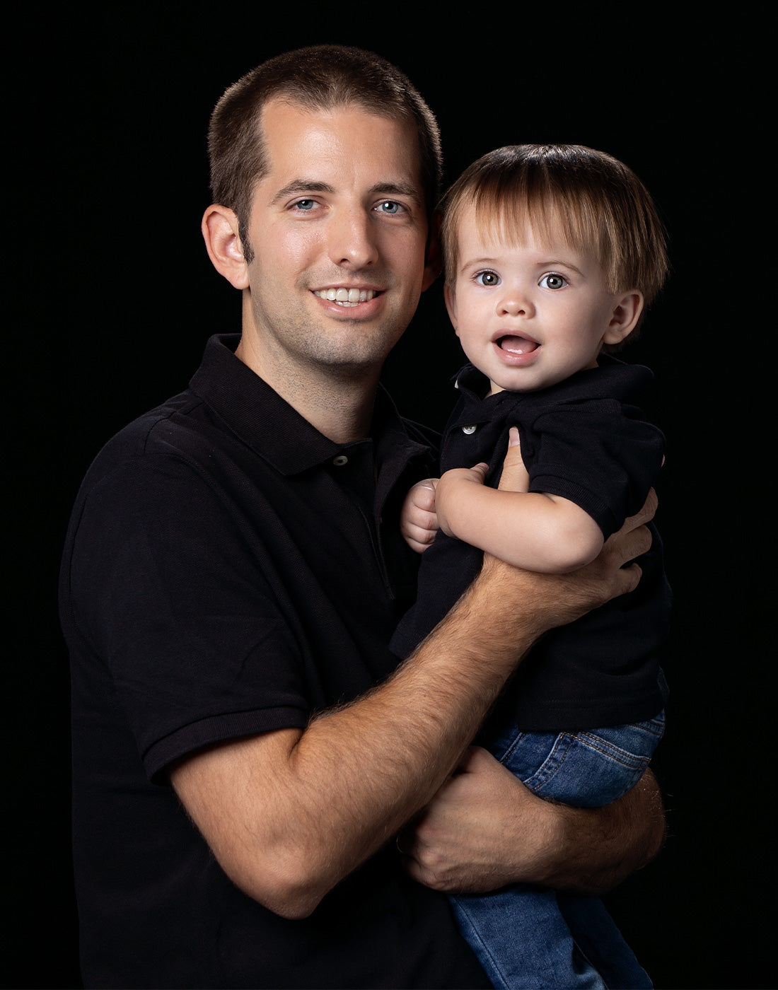 portrait with 2 people on solid black backdrop