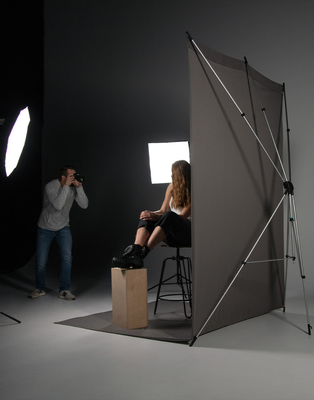 in-studio full-length portrait on chair using gray x-drop sweep backdrop and ulite