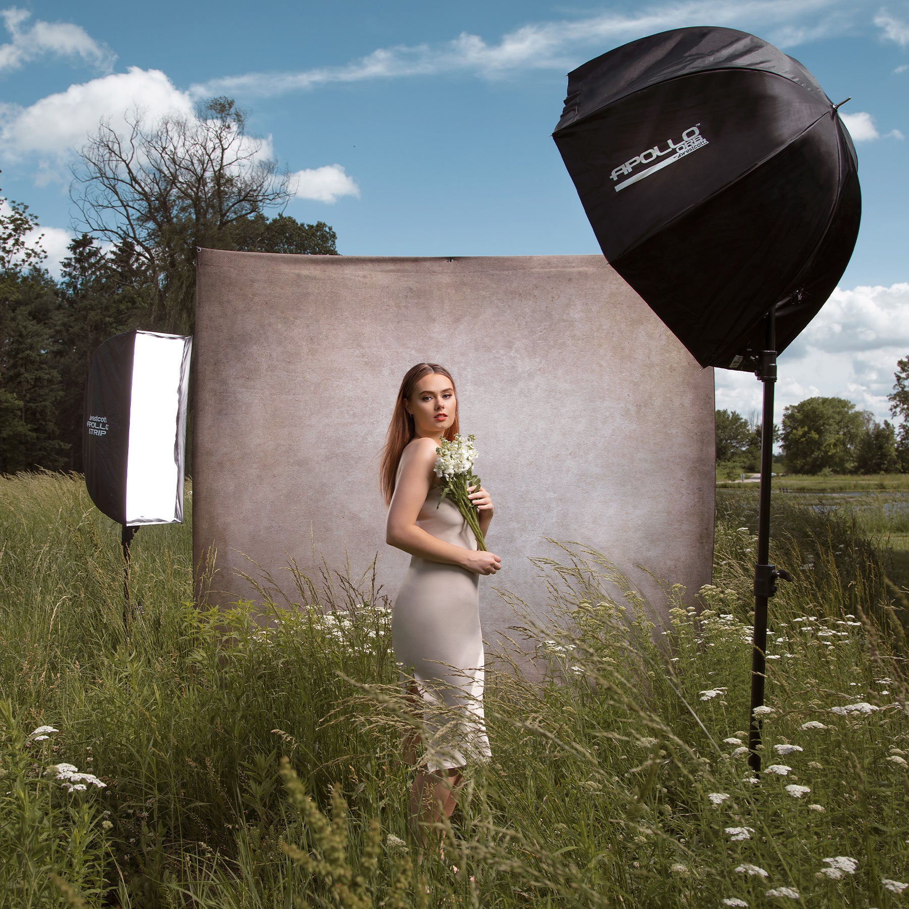 X-Drop Pro Backdrop with Printed Fabric Backdrop Being Used For Outdoor Travel Portrait
