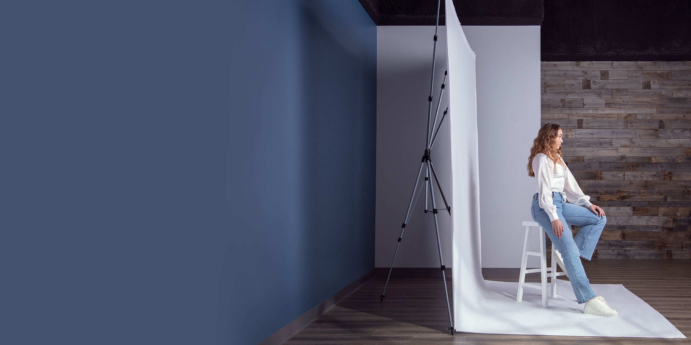 Portrait photo shoot using X-Drop Pro Backdrop Stand showing adjustable depth